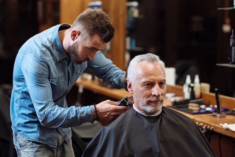 Happy Head Inc customer getting his hair cut in a more flattering way to help hide his hair thinning while he continues his hair loss treatments. 