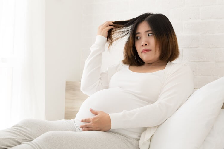 Pregnant woman with hair loss. Hair loss is common among pregnant women and it's usually temporary based on hormonal changes as your body preps for birth. 